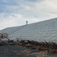 A man walks along the seawall near Watanoha, Miyagi Prefecture. | OSCAR BOYD