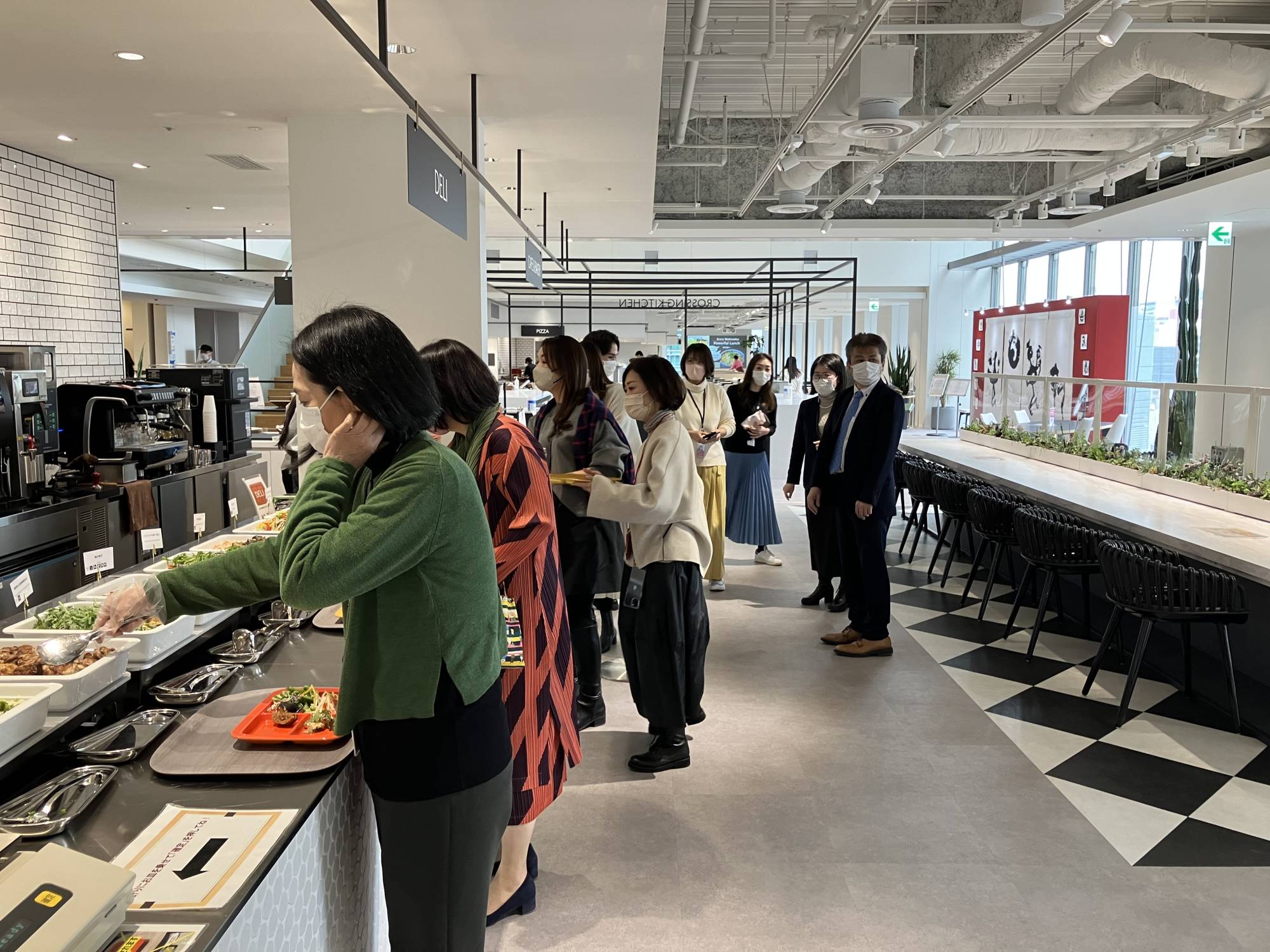 Shiseido employees choose their lunch at the cafeteria at its office in Tokyo’s Shiodome district last month. | KAZUAKI NAGATA
