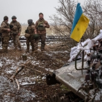 Ukrainian servicemen stand at their positions near a front line in the Donetsk region of Ukraine on Wednesday. | REUTERS
