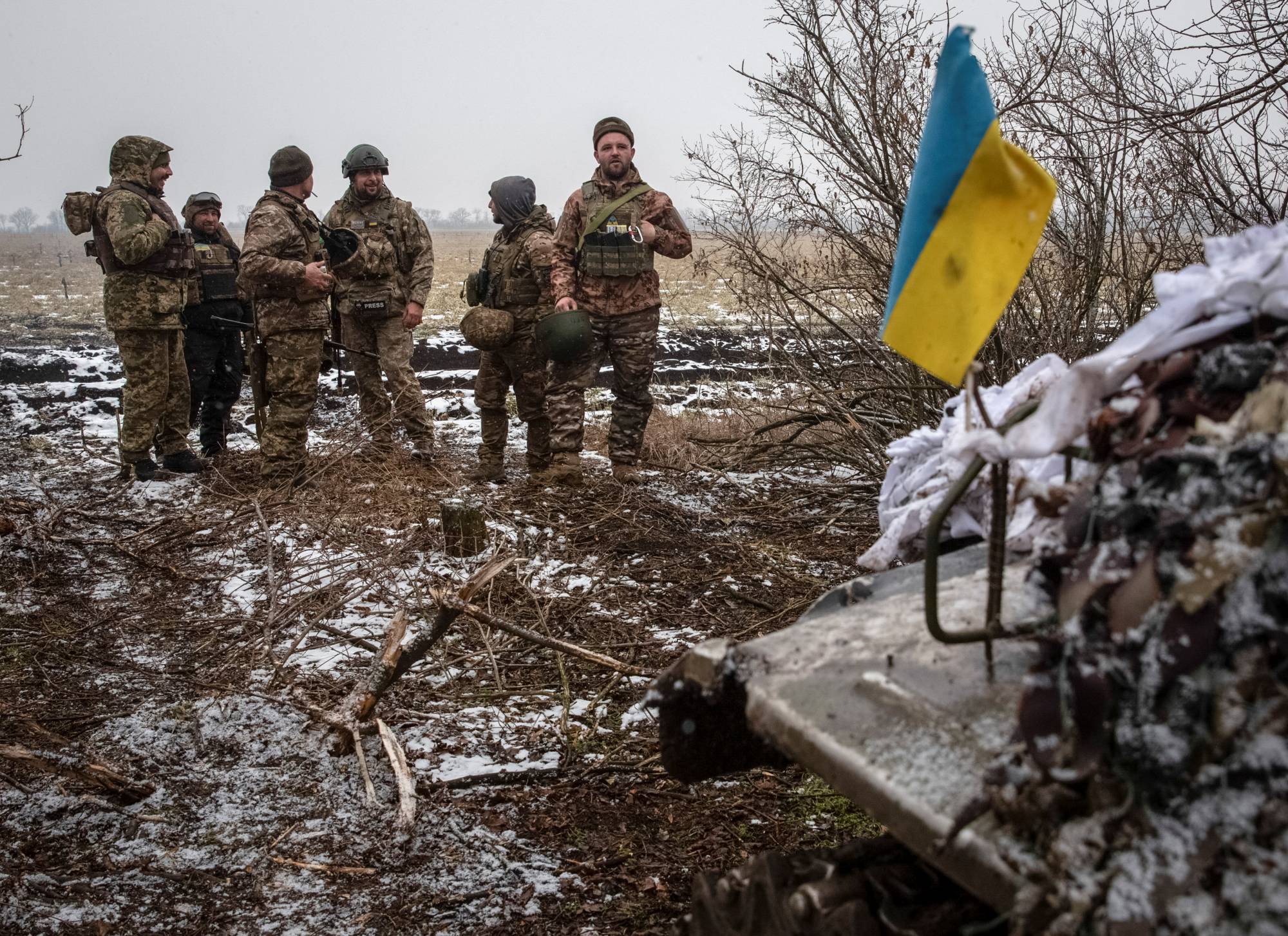 Ukrainian servicemen stand at their positions near a front line in the Donetsk region of Ukraine on Wednesday. | REUTERS