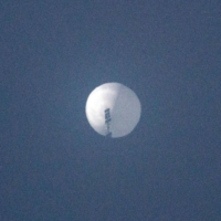 This photo taken on Wednesday and posted to social media the following day shows a suspected Chinese spy balloon in the sky over Billings, Montana.  | CHASE DOAK / VIA AFP-JIJI