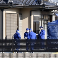 Police inspect the house of Yasuko Komatsu on Friday, who had been found dead in her home in the city of Iwaki, Fukushima Prefecture, in a possible robbery and murder incident. | KYODO 