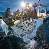 U.S. Navy sailors recover a suspected Chinese surveillance balloon off the coast of Myrtle Beach, South Carolina, in the Atlantic Ocean on Sunday.  | U.S. NAVY / VIA AFP-JIJI