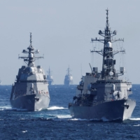 The Maritime Self-Defense Force Takanami destroyer leads a fleet of MSDF vessels during the International Fleet Review to commemorate the 70th anniversary of MSDF\'s foundation, in Sagami Bay, south of Tokyo, last November. | POOL / VIA REUTERS