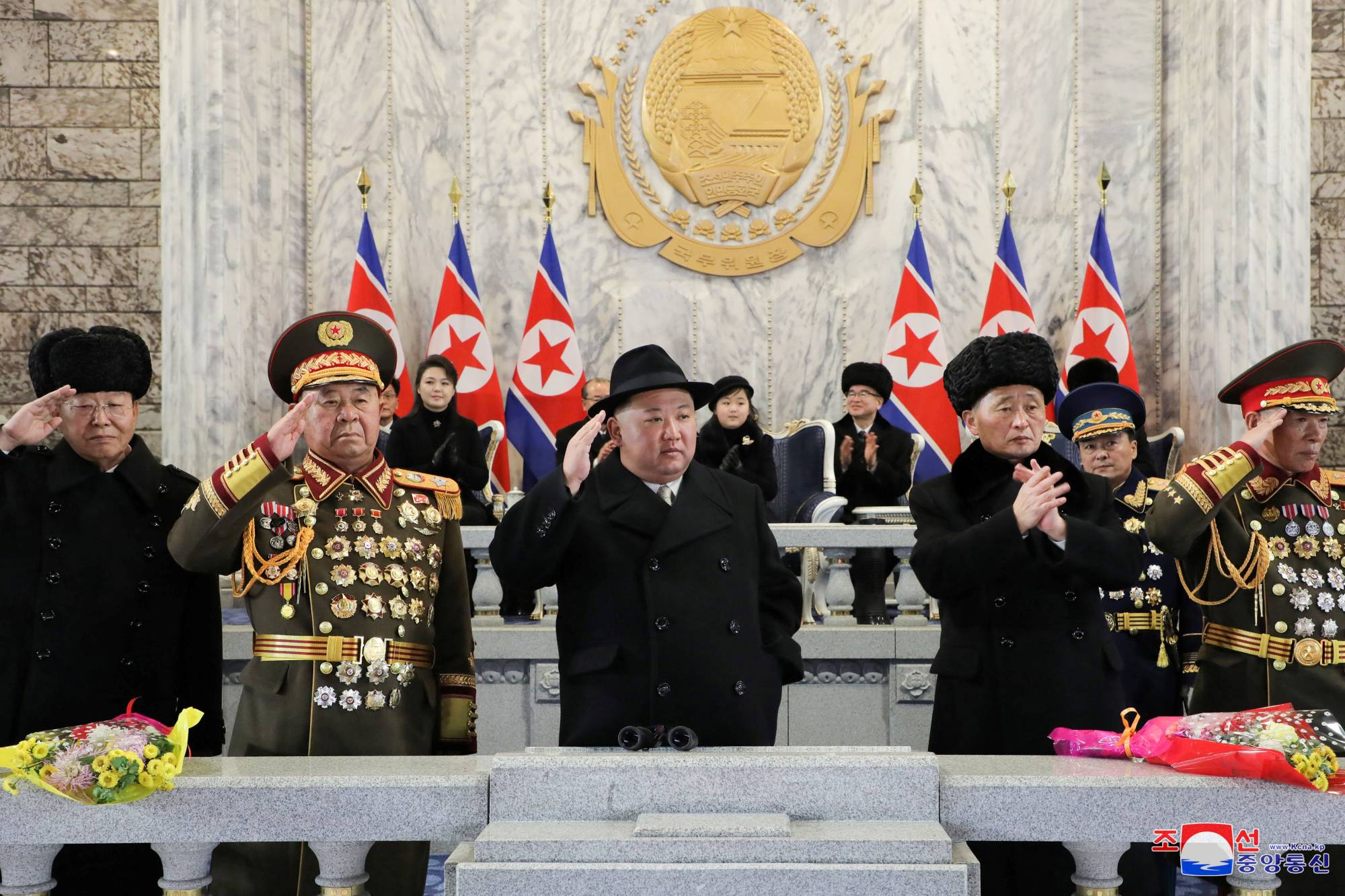 North Korean leader Kim Jong Un, along with his wife, Ri Sol Ju, and their daughter, believed to be named Kim Ju Ae, (seated at the back) attend a military parade to mark the 75th founding anniversary of North Korea's army, at Kim Il Sung Square in Pyongyang on Wednesday. | KCNA / via REUTERS 
