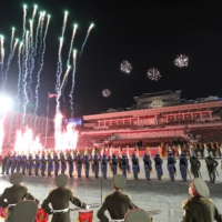 Fireworks are launched during a military parade in Pyongyang on Wednesday. | KCNA / VIA REUTERS  
