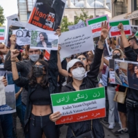 Protesters hold placards during a demonstration over the death of Mahsa Amini, outside the Iranian consulate building in Istanbul, Turkey, in September last year. | BLOOMBERG