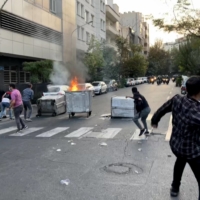 A protest for Mahsa Amini, a woman who reportedly died after being arrested by the Islamic republic\'s \"morality police,\" in Tehran last September. | AFP-JIJI
