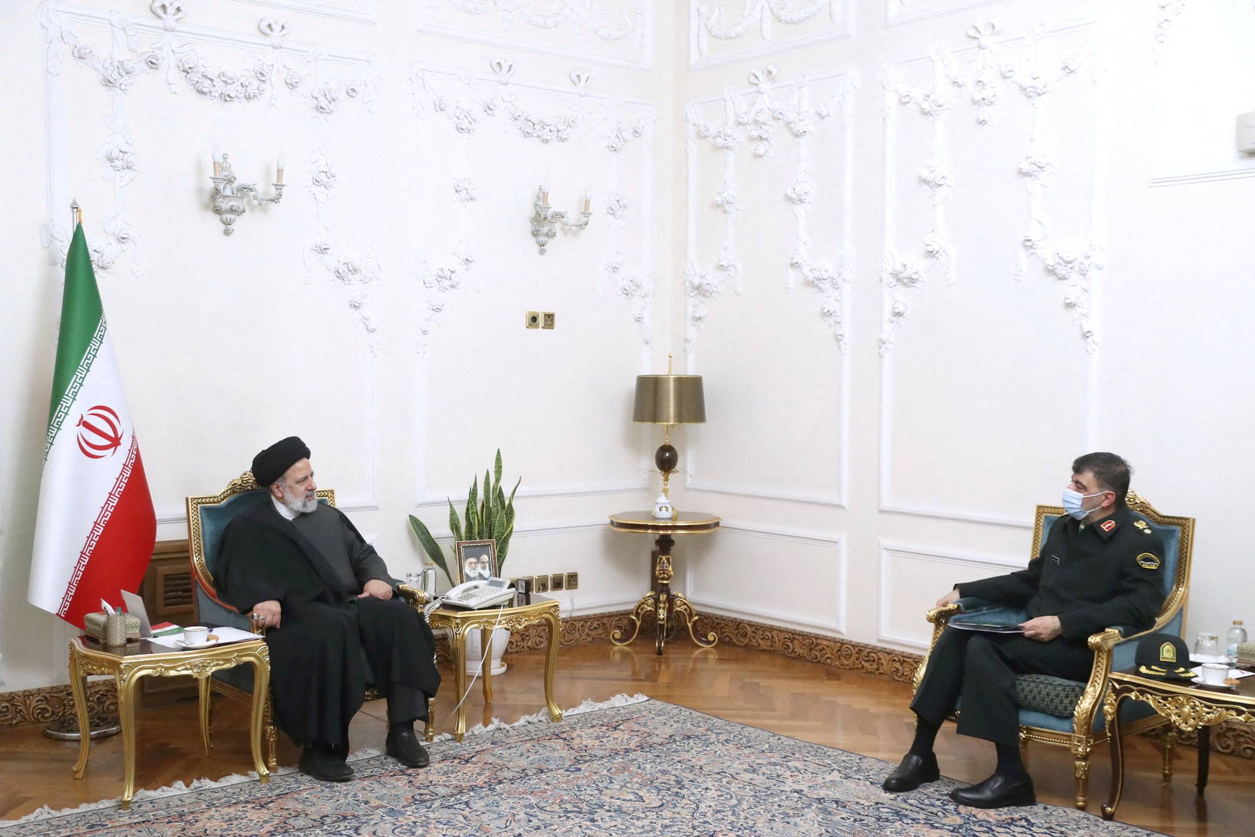 Iranian President Ebrahim Raisi meets with the new chief commander of the Iranian police force, Ahmad-Reza Radan, in Tehran on Jan. 14. | Presidential Website / West Asia News Agency / via REUTERS 