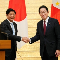 Philippine President Ferdinand Marcos Jr. shakes hands with Prime Minister Fumio Kishida at the prime minister\'s official residence in Tokyo on Thursday. | POOL / VIA AFP-JIJI