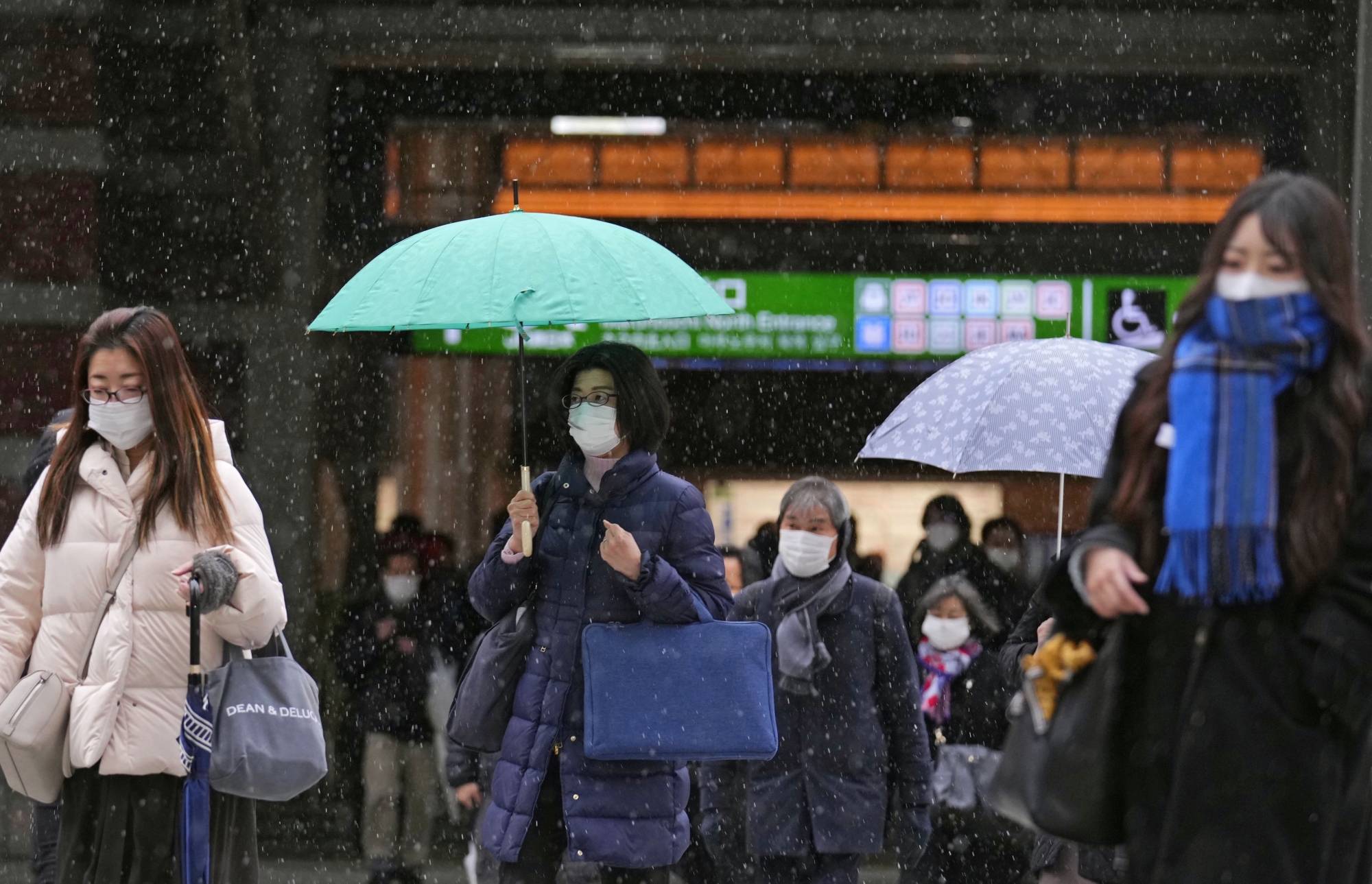 Commuters near Tokyo Station on Friday. While there has never been a mask mandate in Japan, mask-wearing has become a daily custom. | KYODO