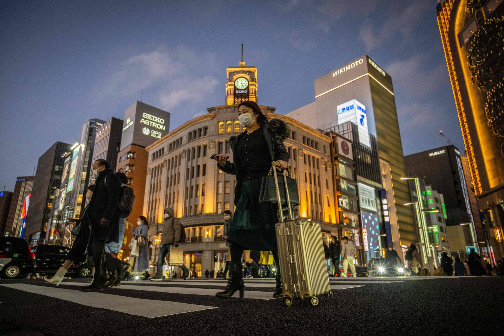 Tokyo's Ginza district last month. Japan spent 22% of its annual budget on debt redemption and interest payments last year, more than the 15% spent on public works, education and defense combined. | AFP-JIJI