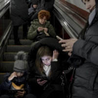 Civilians shelter in a subway station as an air raid alarm sounds in Kyiv on Friday. Russia targeted Ukraine’s already battered infrastructure with drones, rockets and cruise missiles on Friday, raining fire on cities around the country one day after President Volodymyr Zelenskyy wrapped up a two-day push in Europe for more, faster support from Kyiv’s allies.  | EMILE DUCKE / THE NEW YORK TIMES
