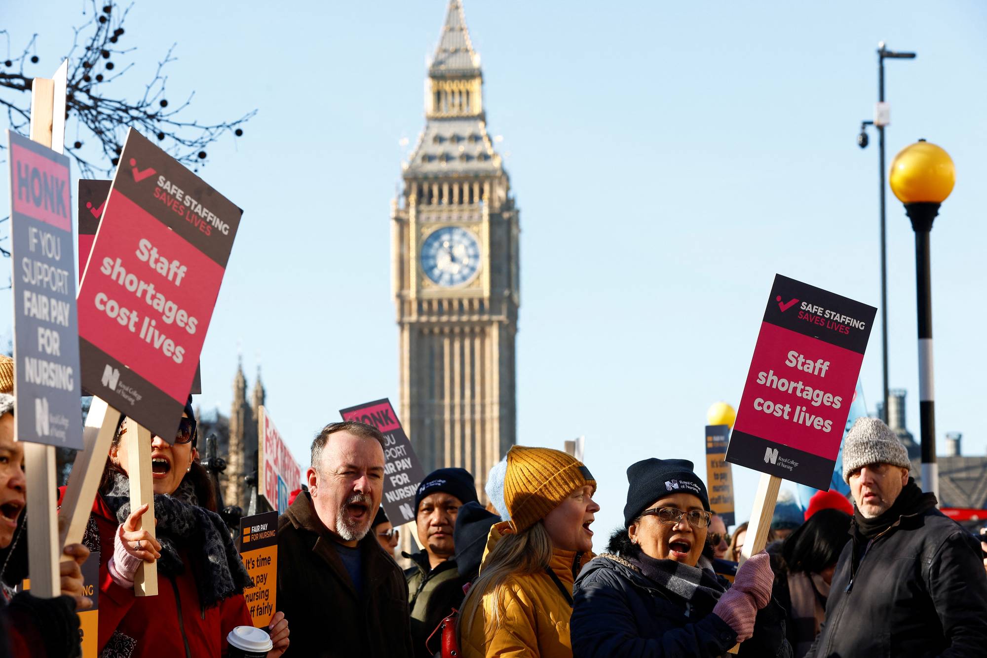 Nurses protest during a strike by NHS medical workers, amid a dispute with the government over pay, outside St. Thomas' Hospital in London on Feb. 6. | REUTERS