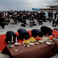 South Korean relatives of workers killed in a disaster at the Chosei coal mine in 1942 bow toward an altar for the victims at a ceremony in Ube, Yamaguchi Prefecture, on Feb. 4. | REUTERS