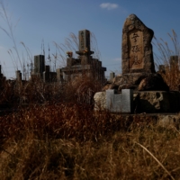 A tombstone for those who have no relatives stands near the Chosei coal mine. A local support group believes it may have been built for the Korean miners killed in the mining disaster. | REUTERS