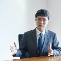 Takuya Hoshino, an economist at the Dai-ichi Life Research Institute, says low wages and employment instability are linked to the country\'s low birthrate. | COURTESY OF TAKUYA HOSHINO