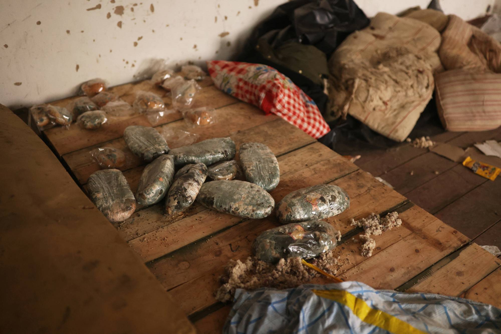 Mouldy bread, mattresses and clothes litter a warehouse where Russian forces were based during their recent occupation | REUTERS