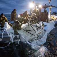 In a photo provided by the U.S. Navy, sailors recover the downed Chinese surveillance balloon off the coast of South Carolina. | TYLER THOMPSON / U.S. NAVY / VIA THE NEW YORK TIMES
