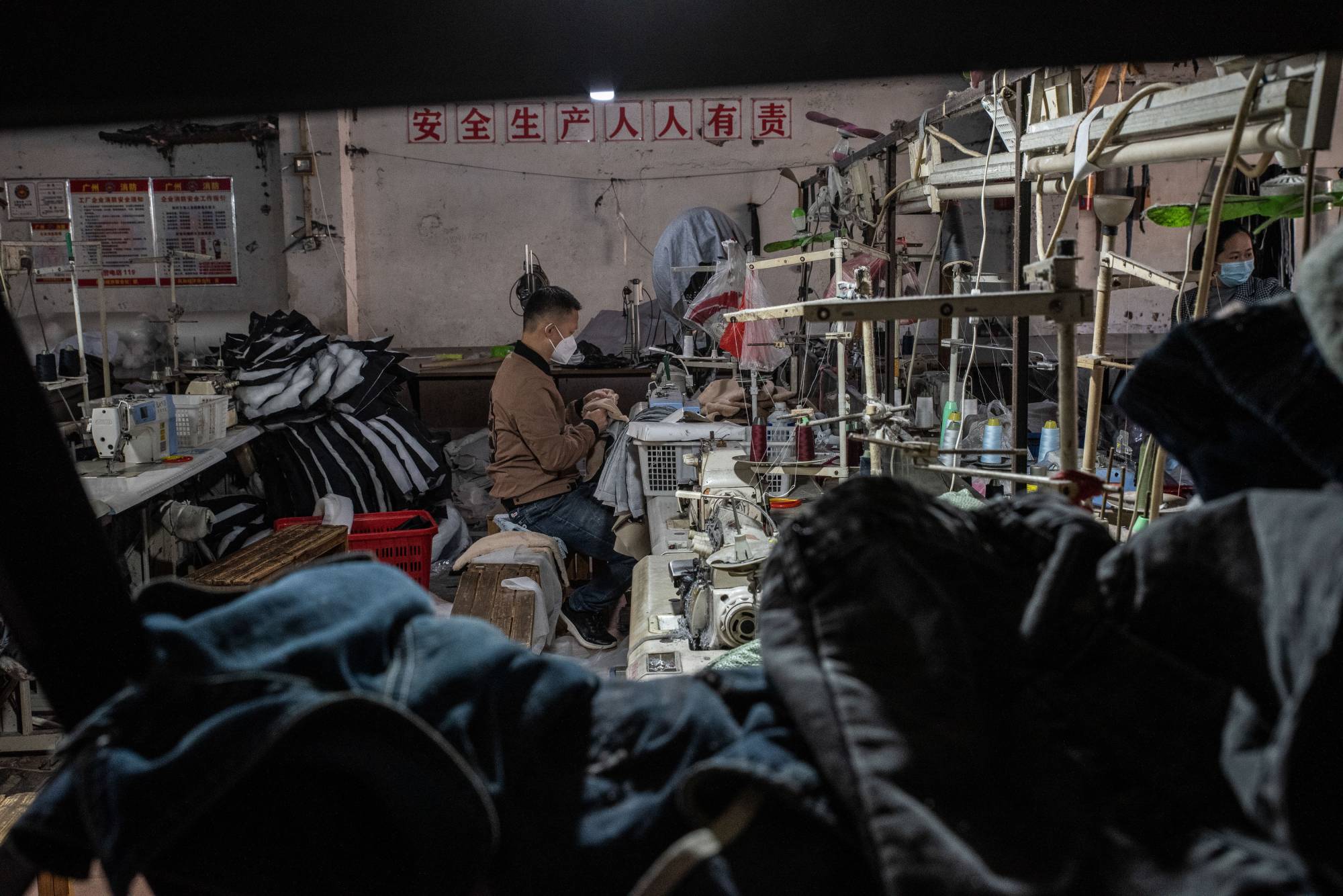 Workers at a clothing factory in Guangzhou. Factory owners and recruiters in the southern metropolis — home to China’s largest garment wholesale markets — say workers are reluctant to come back, scarred by the experience of long lockdowns. | GILLES SABRIE / THE NEW YORK TIMES