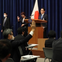 Prime Minister Fumio Kishida takes questions from reporters at his official residence in Tokyo in June.  | POOL / VIA REUTERS