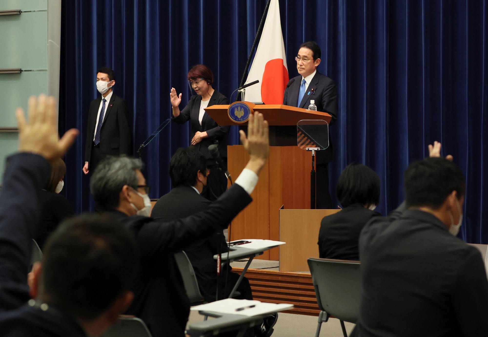 Prime Minister Fumio Kishida takes questions from reporters at his official residence in Tokyo in June.  | POOL / VIA REUTERS