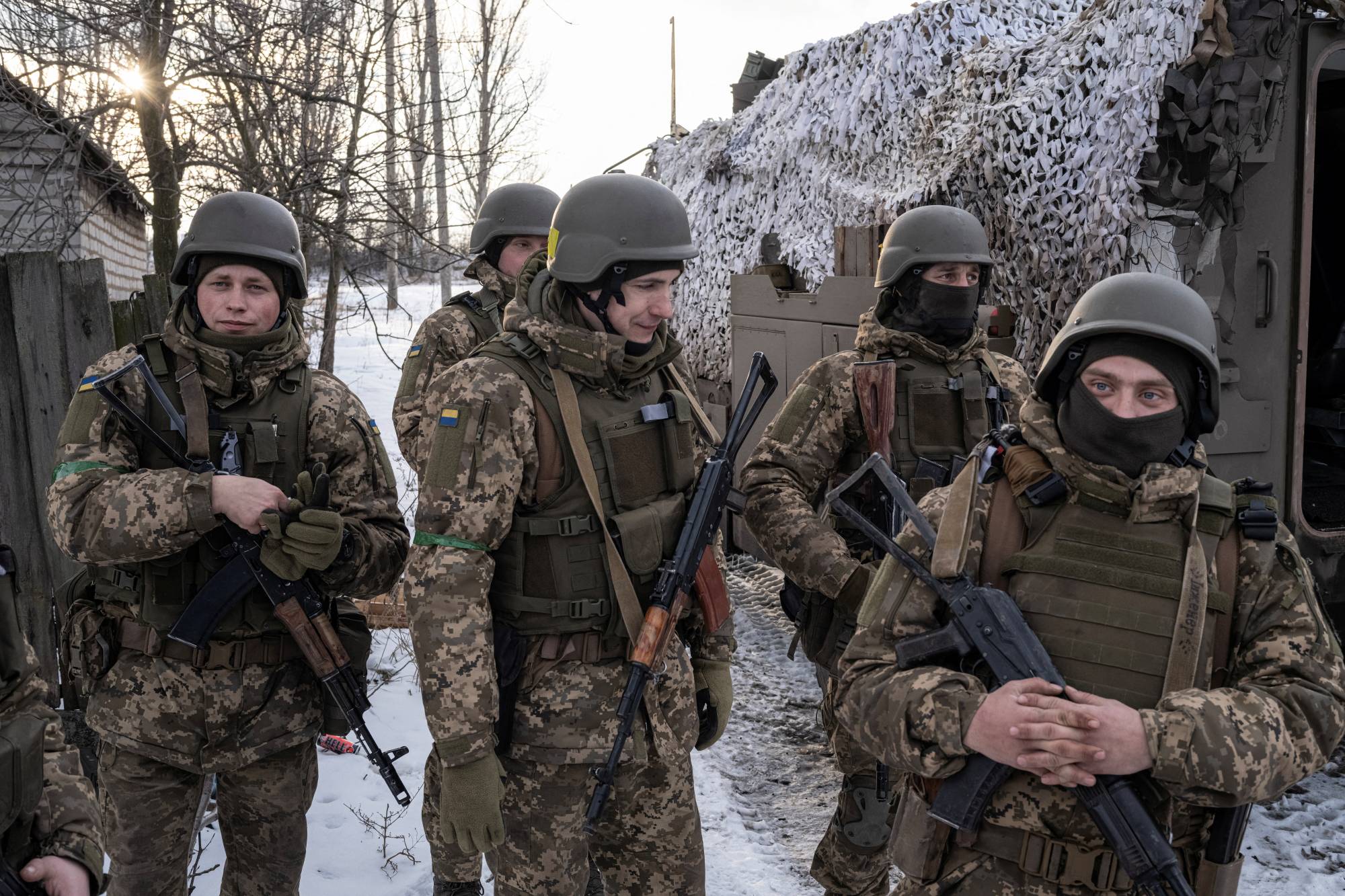 Ukrainian servicemen of the 80th Air Assault Brigade stand in front of a Bushmaster Protected Mobility Vehicle, near Bahmut in the Donetsk region of Ukraine on Thursday. | REUTERS
