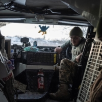 Ukrainian servicemen of the 80th Air Assault Brigade sit inside a Bushmaster Protected Mobility Vehicle, near Bahmut in the Donetsk region of Ukraine on Thursday. | REUTERS