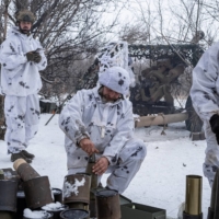Ukrainian servicemen of the 80th Air Assault Brigade prepare to fire an M119 Howitzer artillery weapon toward Russian troops, near Bahmut in the Donetsk region of Ukraine on Thursday. | REUTERS