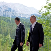 German Chancellor Olaf Scholz and Prime Minister Fumio Kishida meet on the sidelines of the G7 summit in Kruen, Germany, in June of last year.  | POOL / VIA REUTERS