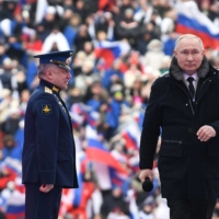 Russian President Vladimir Putin attends a concert at Luzhniki stadium in Moscow on Wednesday.  | SPUTNIK / VIA AFP-JIJI