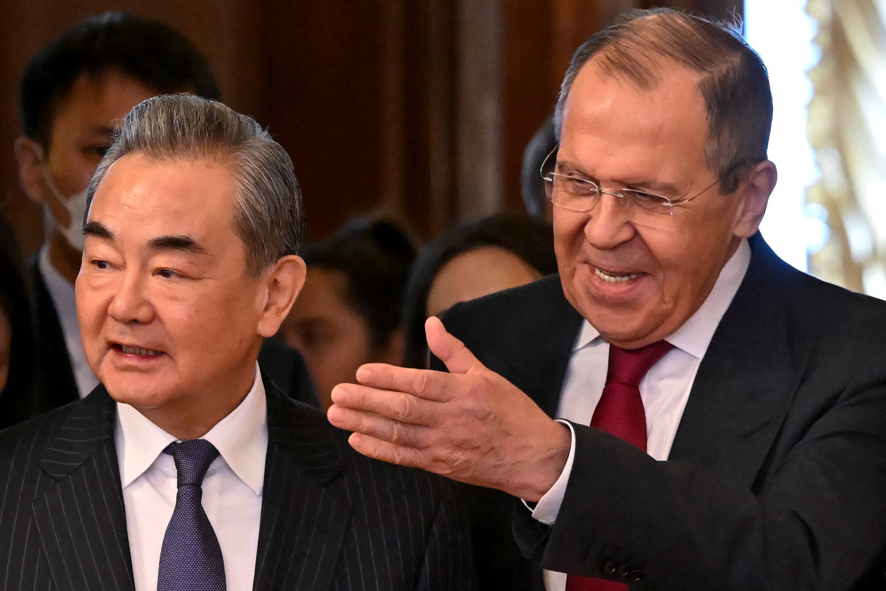China's top diplomat, Wang Yi, and Russian Foreign Minister Sergey Lavrov enter a hall during a meeting in Moscow on Wednesday. | Pool / via REUTERS