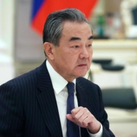Wang Yi, China\'s top diplomat, attends a meeting with Russian President Vladimir Putin at the Kremlin in Moscow on Wednesday. | SPUTNIK / VIA AFP-JIJI