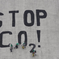 Greenpeace activists paint \"Stop CO2\" on smoke stack at a power plant in Poland in July 2007.   | REUTERS