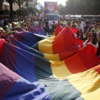 Participants wave a rainbow flag in Seoul.  | REUTERS