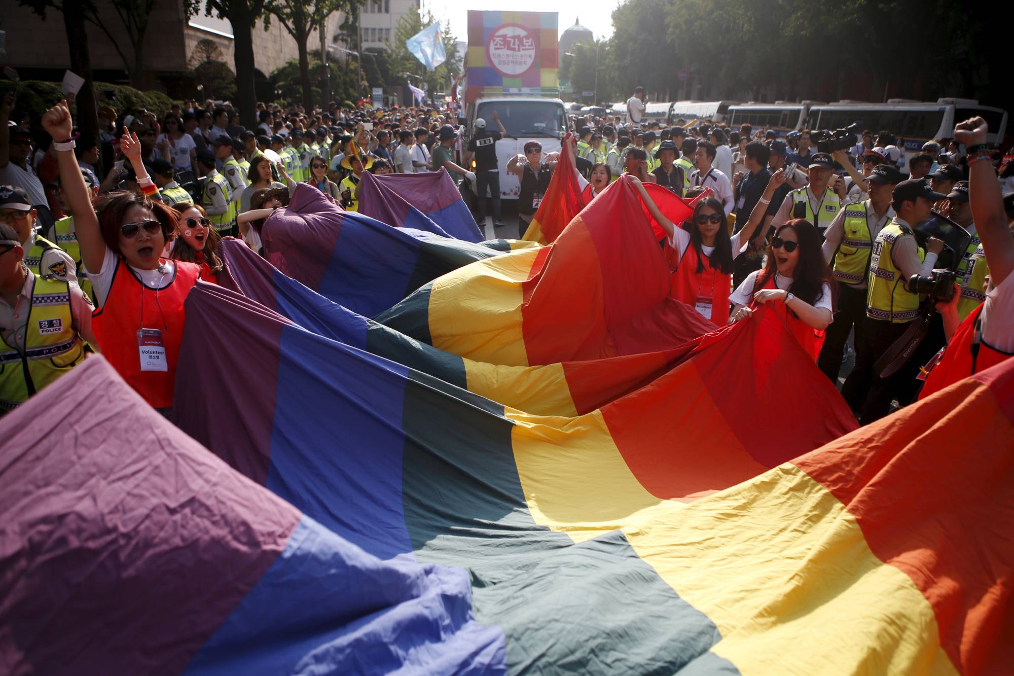 Participants wave a rainbow flag in Seoul. | REUTERS