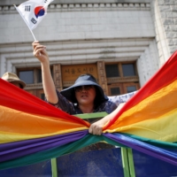 A Christian grabs a rainbow flag while protesting against homosexuality during the Korea Queer Festival in 2015.  | REUTERS