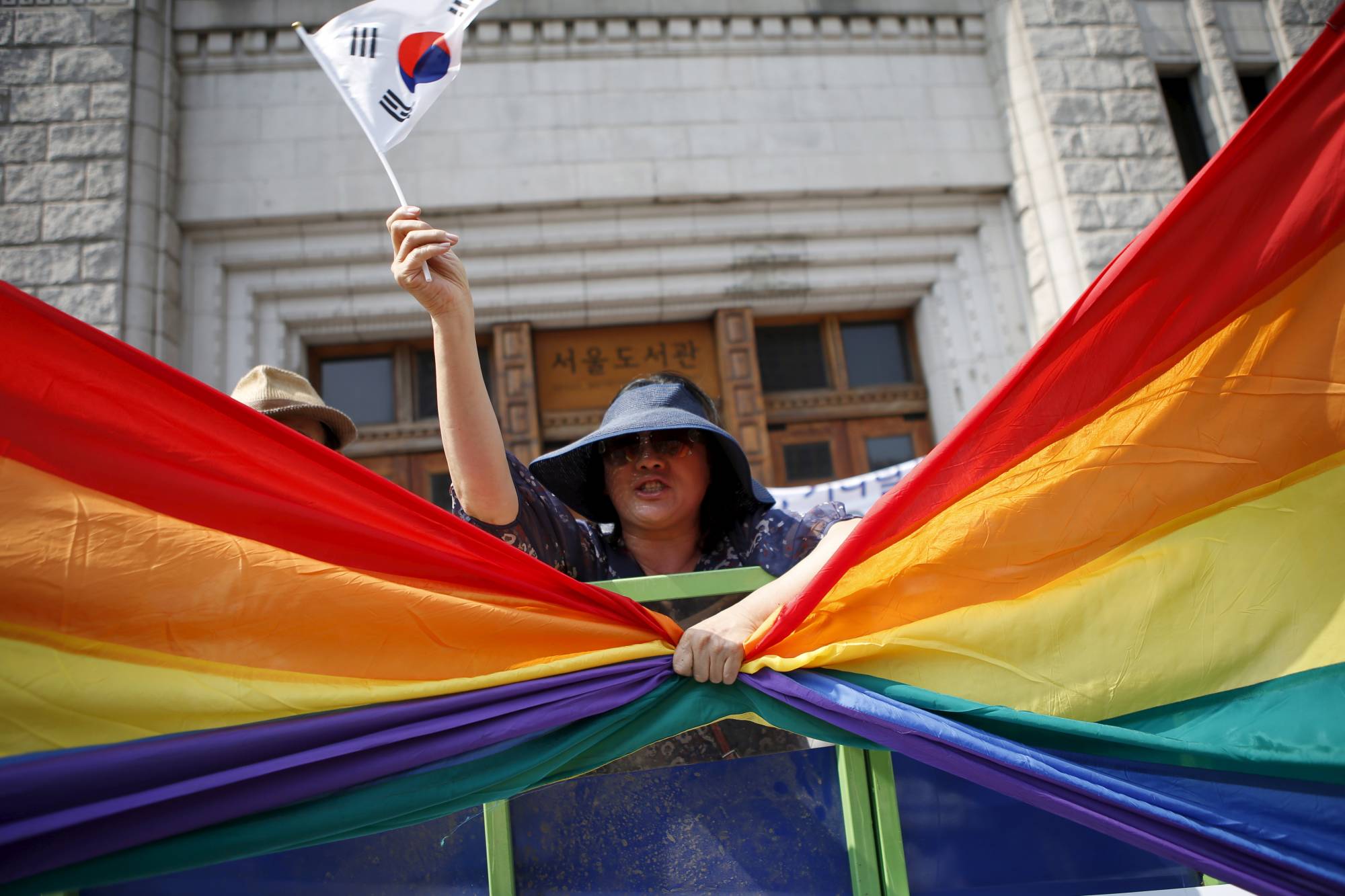 A Christian grabs a rainbow flag while protesting against homosexuality during the Korea Queer Festival in 2015. | REUTERS