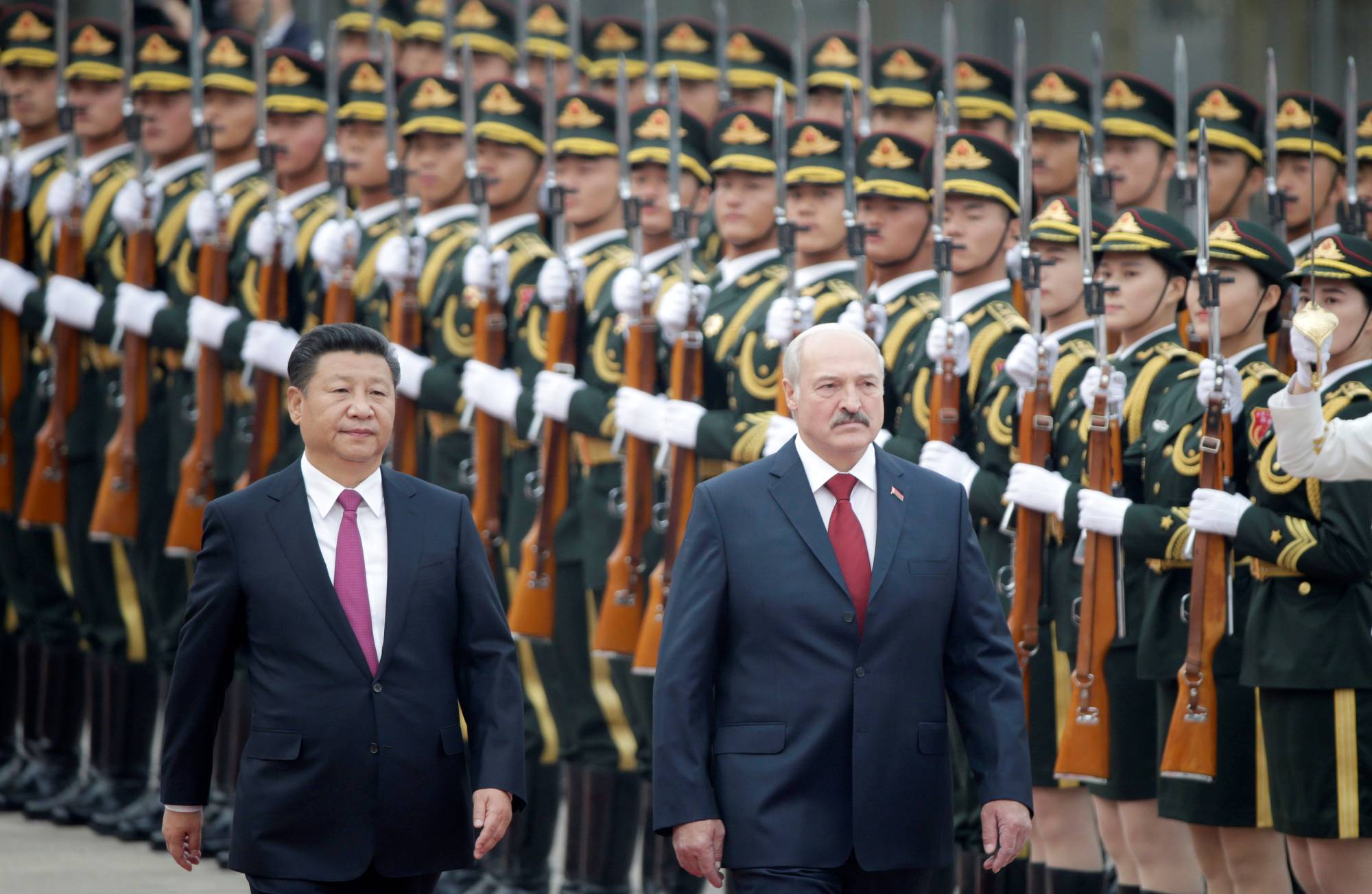 China's leader Xi Jinping and Belarus President Alexander Lukashenko review honor guards during a welcoming ceremony at the Great Hall of the People in Beijing in 2016.  | REUTERS