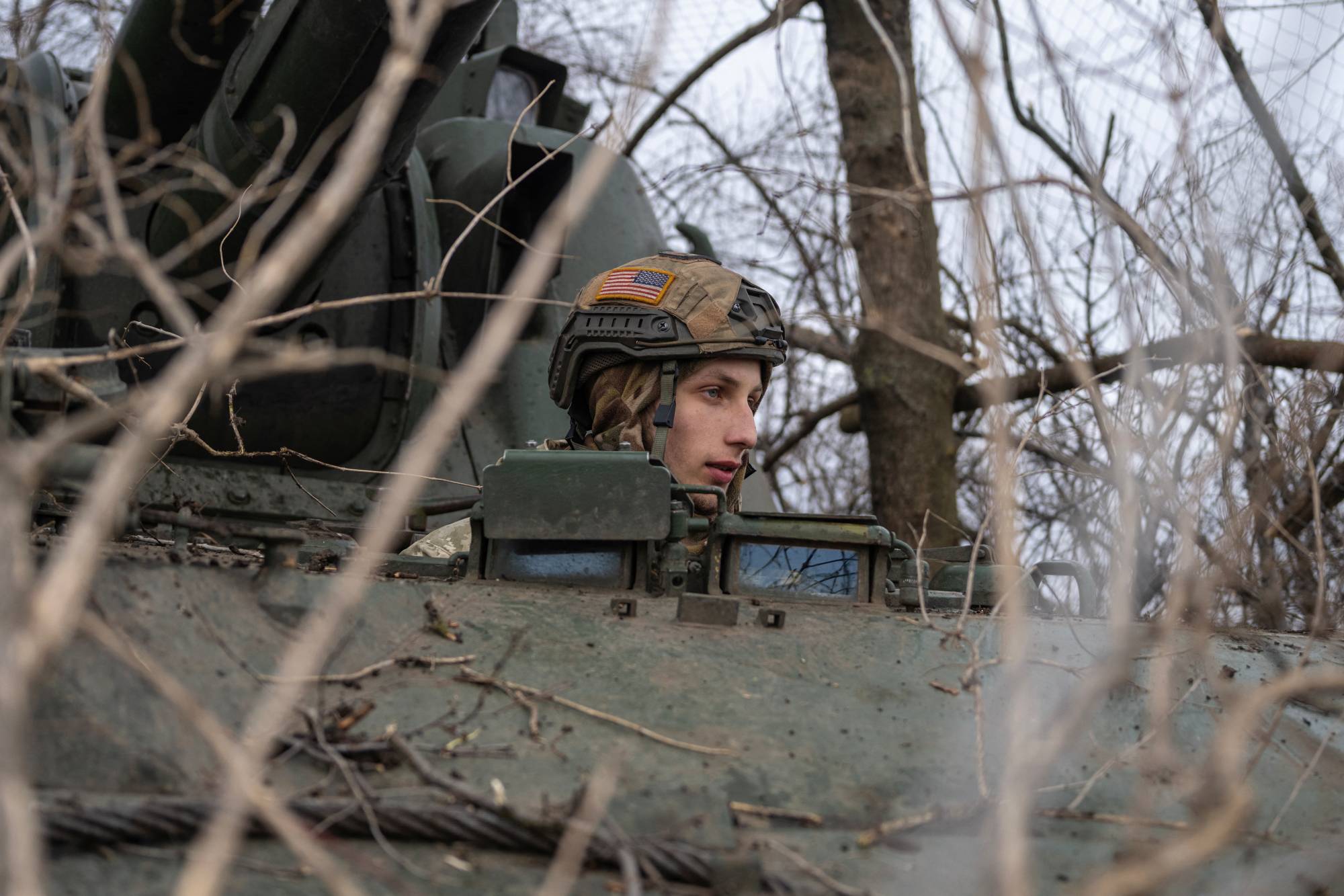 A Ukrainian serviceman sits inside a self-propelled howitzer near the front-line town of Bakhmut, Ukraine, on Saturday. | Reuters
