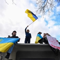 Protesters demonstrate to show solidarity with Ukraine at a rally in Paris on Saturday. | AFP-JIJI