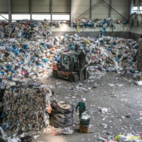 A worker pulls containers of plastic waste at a facility in Gwangmyeong, South Korea, in 2018 | BLOOMBERG