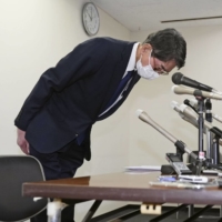 Makoto Yamada, head of the Daimaru Besso inn, apologizes during a news conference in the city of Fukuoka on Tuesday. | KYODO