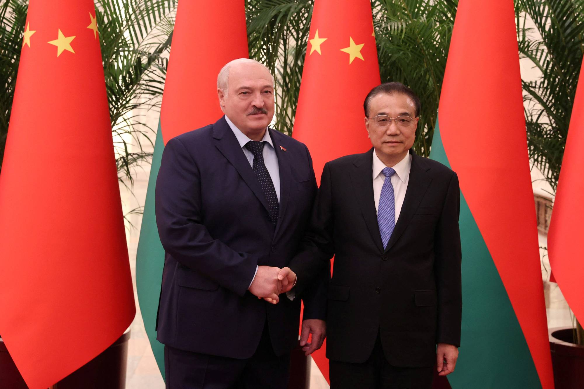 Belarusian President Alexander Lukashenko shakes hands with Chinese Premier Li Keqiang during a meeting in Beijing on Wednesday. | MAXIM GUCHEK / BELTA / VIA REUTERS