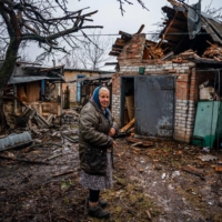 A woman stands in her backyard after shelling in Chasiv Yar, near Bakhmut, Ukraine, on Tuesday.  | AFP-JIJI