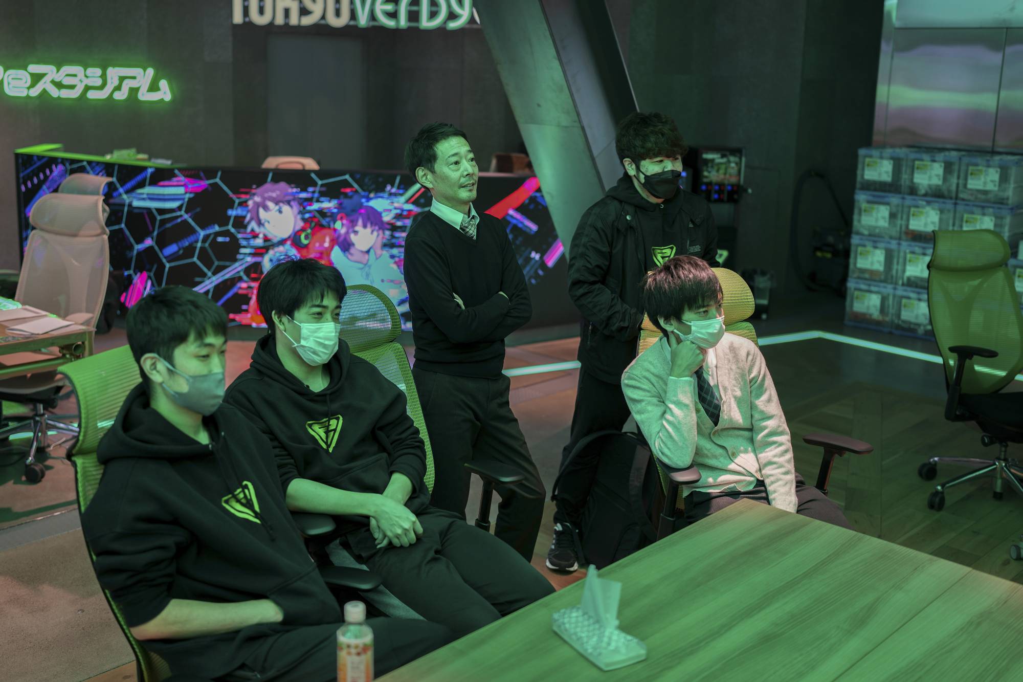 Staff watch as students compete in a video game tournament at Japan's first esports high school. | Chang W. Lee / The New York Times 