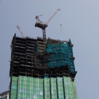 An under-construction skyscraper is seen after a blaze is put out at Tsim Sha Tsui in Hong Kong on Friday | REUTERS