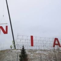 Workers dismantle a Nissan sign after the Japanese automaker completed the sale of its Russian legal entity to state-owned NAMI, in St. Petersburg in November. | REUTERS