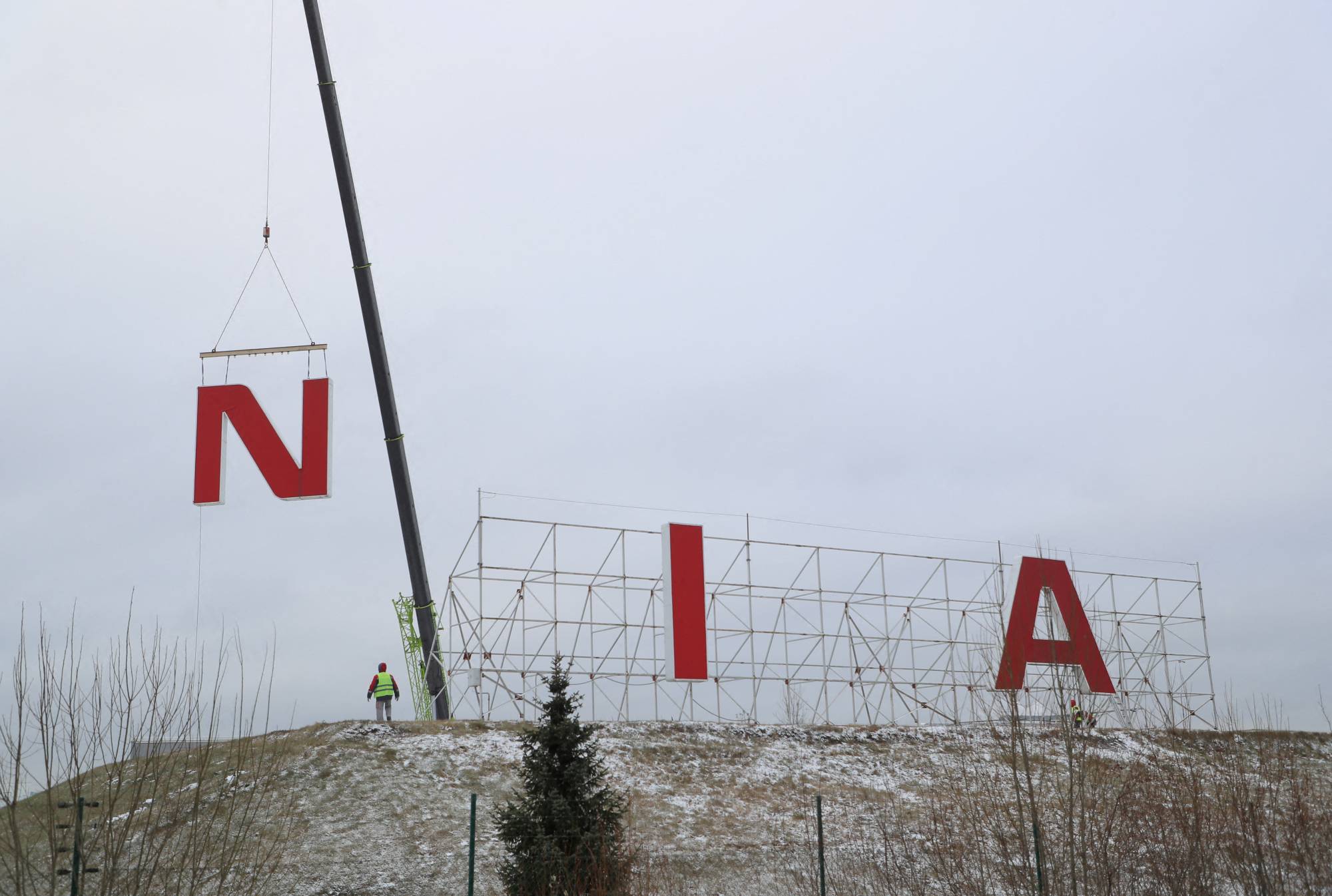 Workers dismantle a Nissan sign after the Japanese automaker completed the sale of its Russian legal entity to state-owned NAMI, in St. Petersburg in November. | Reuters