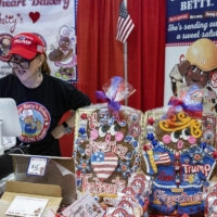A vendor sells gingerbread cookies, including one made to look like Donald Trump, during the CPAC gathering in National Harbor, Maryland.  | HAIYUN JIANG / THE NEW YORK TIMES